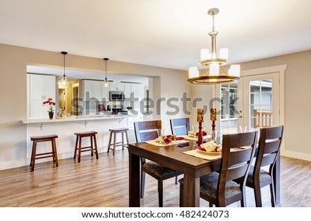 Open floor plan spacious room interior. Dining area with dark brown wooden table set. Northwest, USA