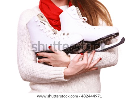 Winter sport equipment concept. Close up picture of ice skates. Woman with white jumper.