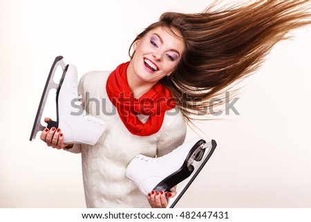 Winter skate sport people concept. Crazy girl with ice skates. Young woman has white outfit and long beutiful hair.