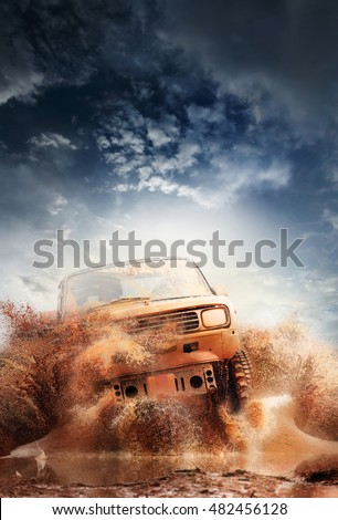 Off road vehicle coming out of a mud hole hazard,mud and water splash in off-road racing. Royalty-Free Stock Photo #482456128