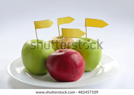 four apples with label on a plate