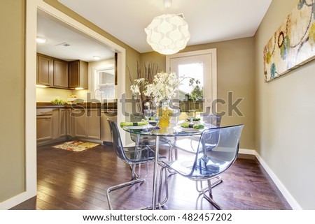 Modern dining area with glass table set. Open floor plan. Northwest, USA
