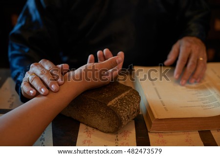 Asian traditional practitioner checking pulse of patient before treatment Royalty-Free Stock Photo #482473579