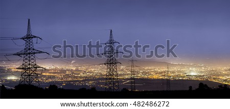 High power electricity poles in urban area. Energy supply, distribution of energy, transmitting energy, energy transmission, high voltage supply concept photo. Royalty-Free Stock Photo #482486272