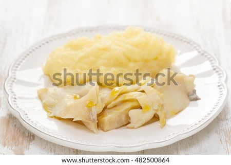 cod fish with mashed potato on white plate