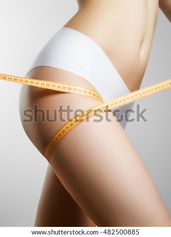Beautiful slim woman's body. Perfect slim toned young body of the girl. Fitness or plastic surgery and aesthetic cosmetology. Taut elastic ass. Firm buttocks Royalty-Free Stock Photo #482500885
