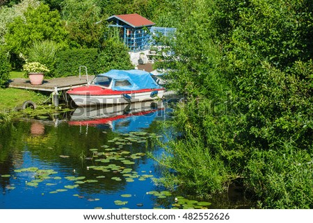Boatshouse on the river Warnow in Rostock (Germany). Royalty-Free Stock Photo #482552626