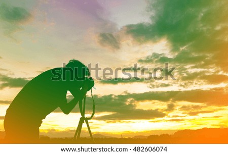 Silhouette of photography with camera in vintage color tone 