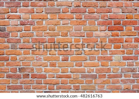 background of old vintage red, orange and yellow wall with bricks in different sizes and color shades
