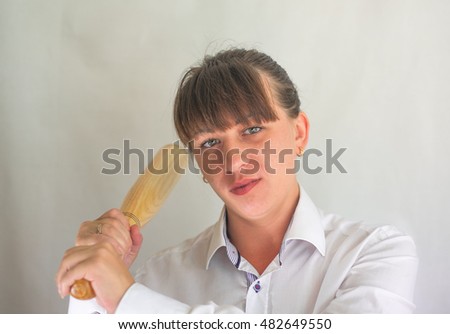 Portrait of dangerous young woman with baseball bat