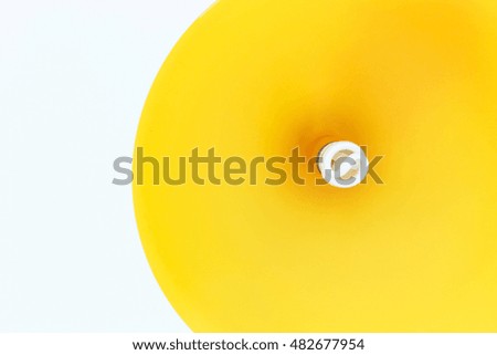 Yellow lamp on white background.