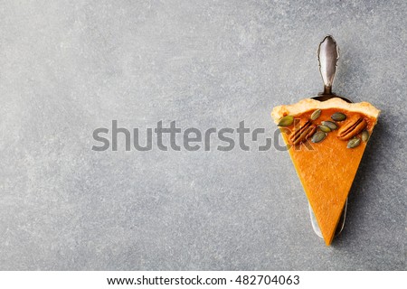 Pumpkin pie, tart made for Thanksgiving day. Grey stone background. Top view. Copy space.