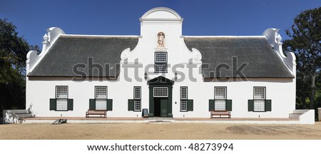 A traditional Cape Dutch homestead on a wine farm called Groot Constantia, Cape Town, South Africa Royalty-Free Stock Photo #48273994