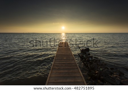 Empty pontoon over a lake at sunrise