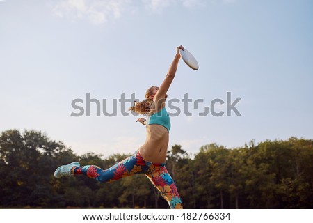 Young athletic girl playing ultimate frisbee