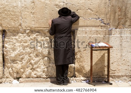  Ultra-orthodox man in black praying at the Wailing Wall, Jerusalem Royalty-Free Stock Photo #482766904