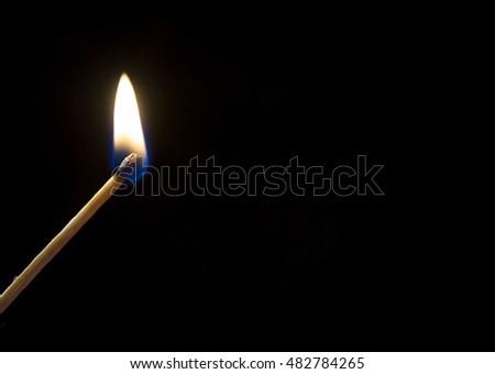Burning match. A photo close up, a dark background