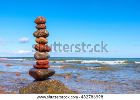 Stones balance on the sea. Summer rock Zen