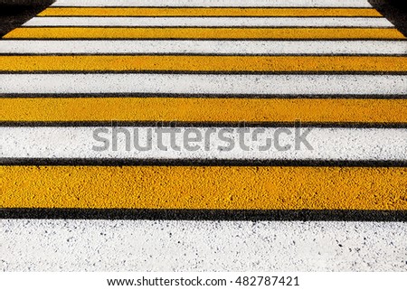 pedestrian crossing. stripes of white and yellow