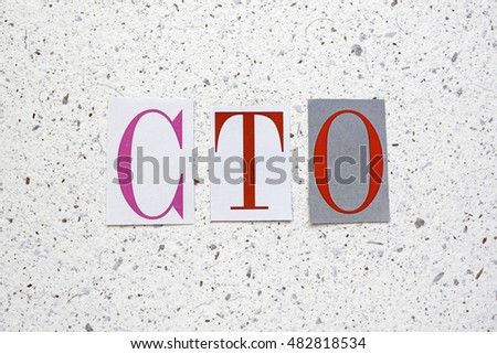 CTO (Chief Technology Officer) acronym cut from newspaper on white handmade paper texture