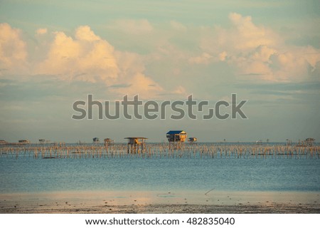 Sea mud dry morning fisherman house and fishing boat in surat thani Thailand during sunrise.

