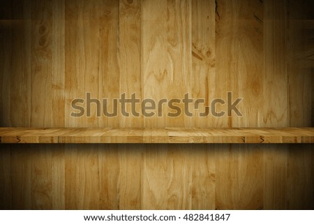 Empty top wooden shelf in front of a grunge wood wall.background. For montage product display
