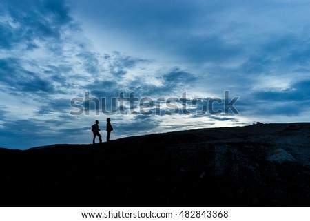 Couple on the hill in Silhouette