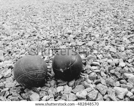 old Petanque ball  or Metallic petanque balls on fine stone field. 