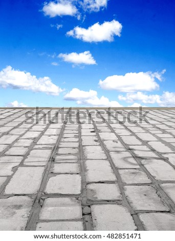 old brick road on the blue sky background