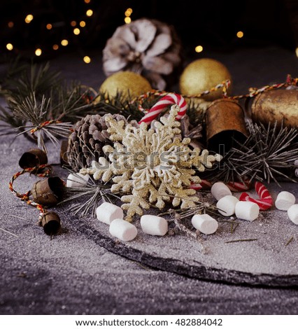 Christmas decoration with fir branches, tangerines, pine cones, and decoration elements , selective focus