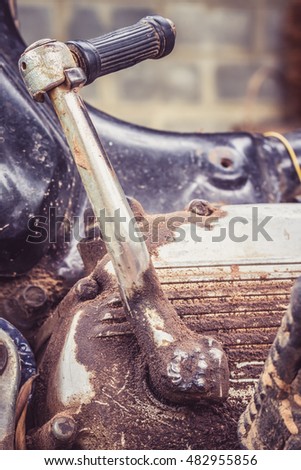 Motorcycle kick starter and shabby dirty engine in vintage style