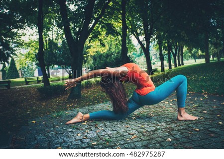 young woman practice yoga  in park summer morning
