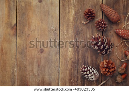 Top view of pine cones on rustic wooden background