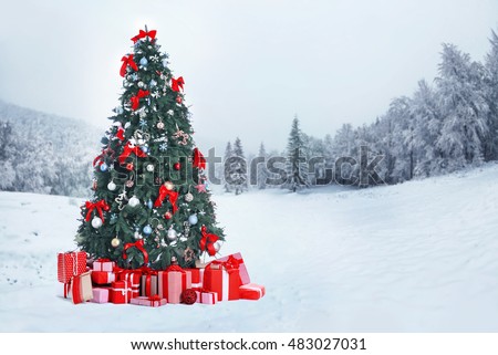 Decorated Christmas tree with gifts on nature background. Christmas holiday concept.