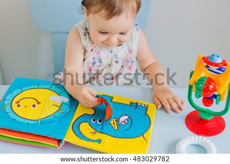 small child playing with soft book Royalty-Free Stock Photo #483029782