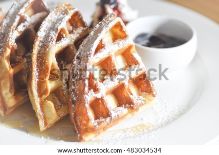 waffle with icing sugar and blueberry dip