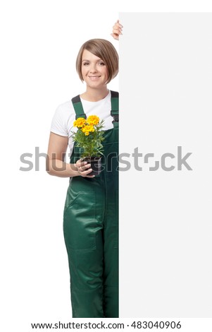 smiling woman gardener with flower standing next to the banner with empty copy space for your text isolated on white background. advertisement blank board. your text here. gardening service concept