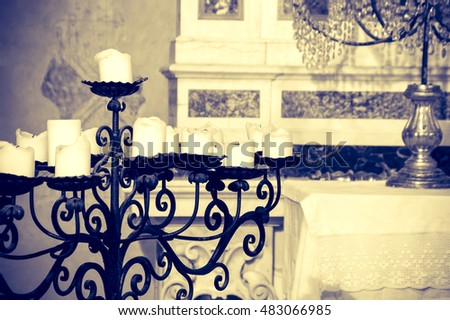 Iron candelabra in a church, artistic sepia edit with copy space for text