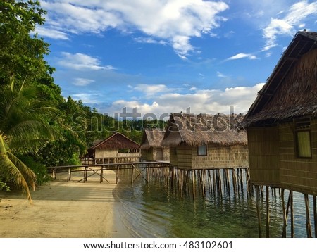 Overwater traditional bungalows of "Papua Paradise Eco Resort" in Raja Ampat Royalty-Free Stock Photo #483102601