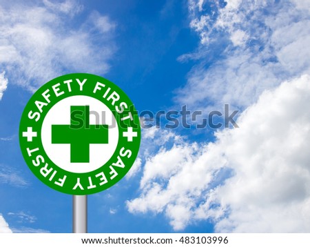 wording "Safety first" in green traffic sign on blue sky background