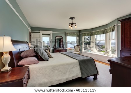 Luxury bedroom interior in blue tones and king size bed. Also perfect water view. Northwest, USA