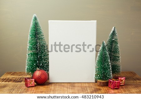 Christmas holiday mock up with canvas and pine tree on wooden table