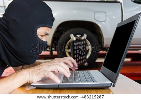 Computer hacker, blur image of inside the tire shop as background.