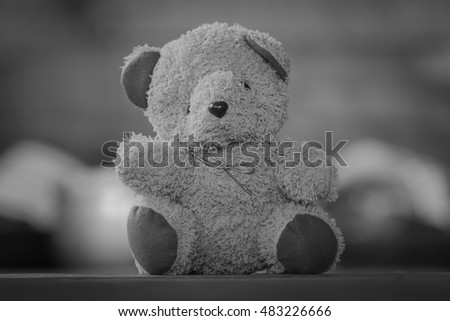 black and white Cute teddy bears sitting on old wood background