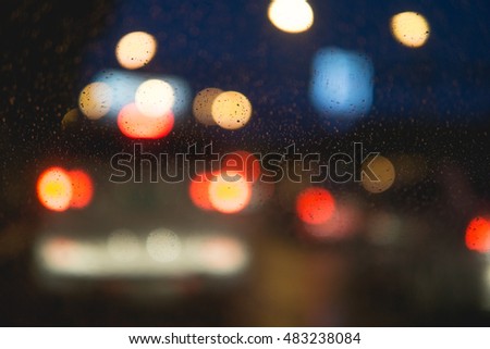 Abstract blurry traffic road bokeh light view from inside a car, Abstract blur bokeh background with rain, rain drop, rainy day