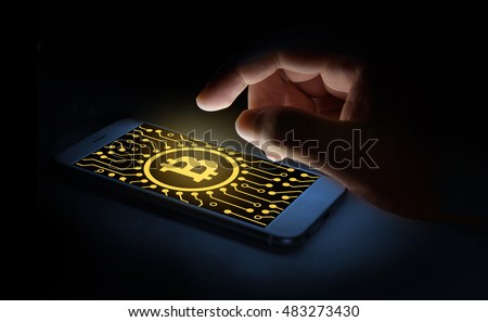 Cyptocurrency or digital money concept image.Bitcoin sign and electrical circuit icon on smartphone screen and finger point to phone screen .Fintech Investment Financial Internet Technology Concept. Royalty-Free Stock Photo #483273430