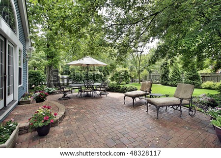 Brick patio with table umbrella and chairs