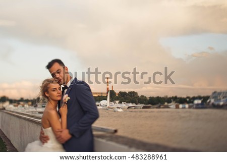 a young married  couple out for a walk near the lake