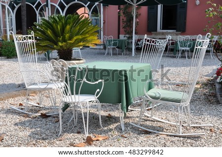 Cafe chairs and table at autumn