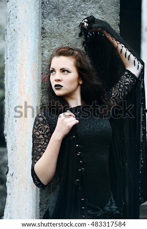 Young modern beautiful witch in the black shawl